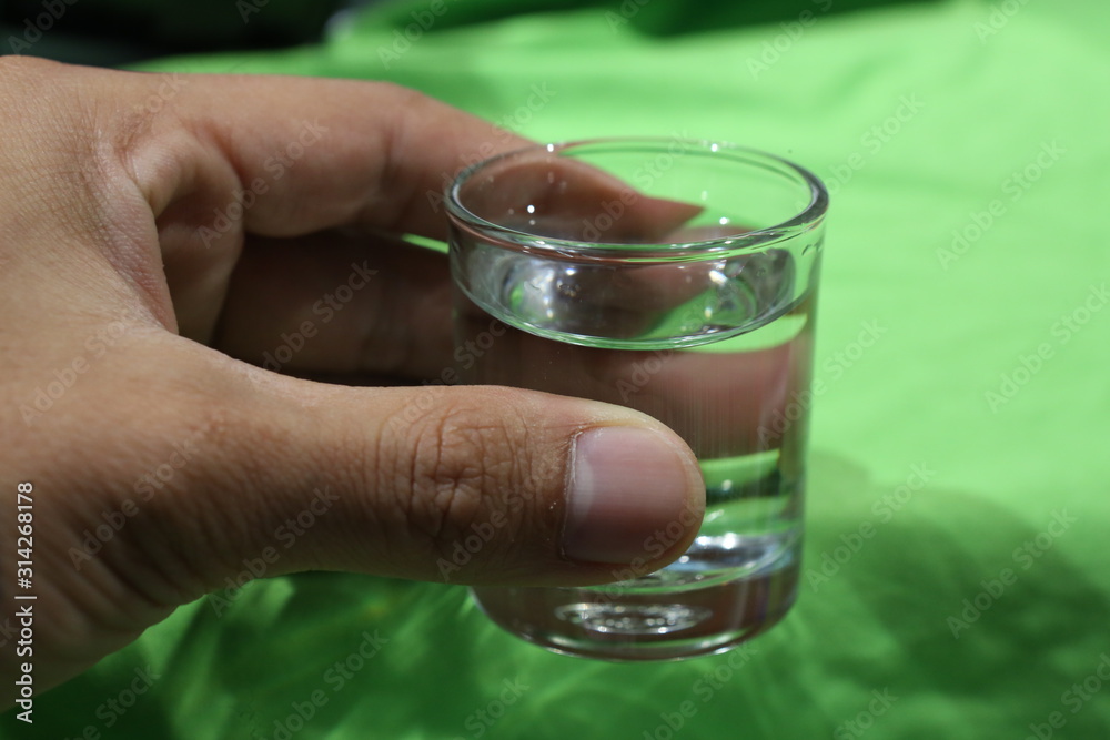 hand with a glass of water hand with a glass of water