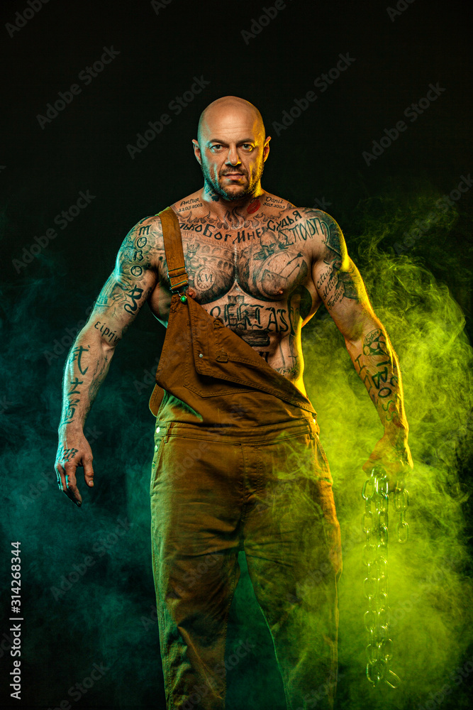 Fototapeta premium Muscular fitness sports man, atlete with chains in fitness gym. Energy and power.