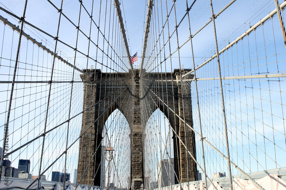 Obraz premium brooklyn bridge in new york with the American flag waving