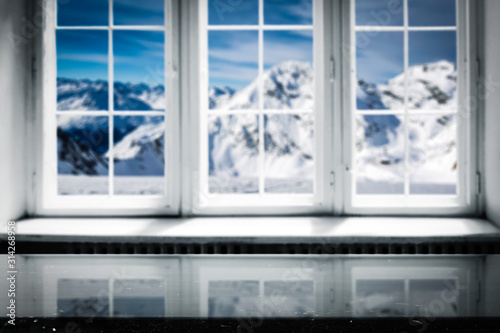 Desk of free space and blurred winter window background. 