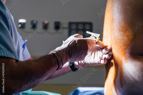 The doctor prepares the injection epidural