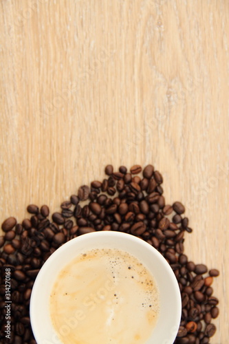 a cup with coffee and coffee beans