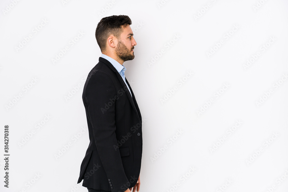 Young caucasian business man against a white background isolated gazing left, sideways pose. Young caucasian business man against a white background isolated gazing left, sideways pose.