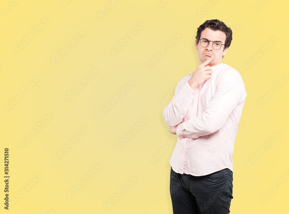 Concerned young man making a gesture of doubt Concerned young man making a gesture of doubt