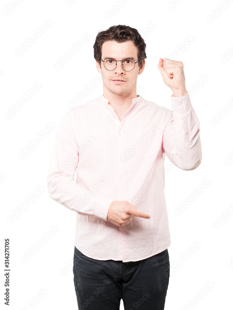 Serious young man making a gesture of strength Serious young man making a gesture of strength