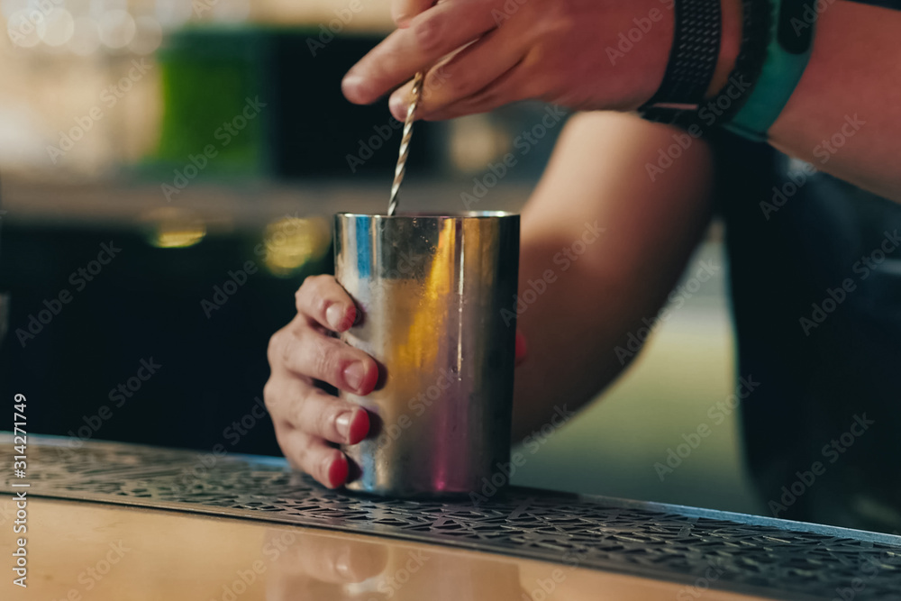Bartender pouring cocktail at bar counter