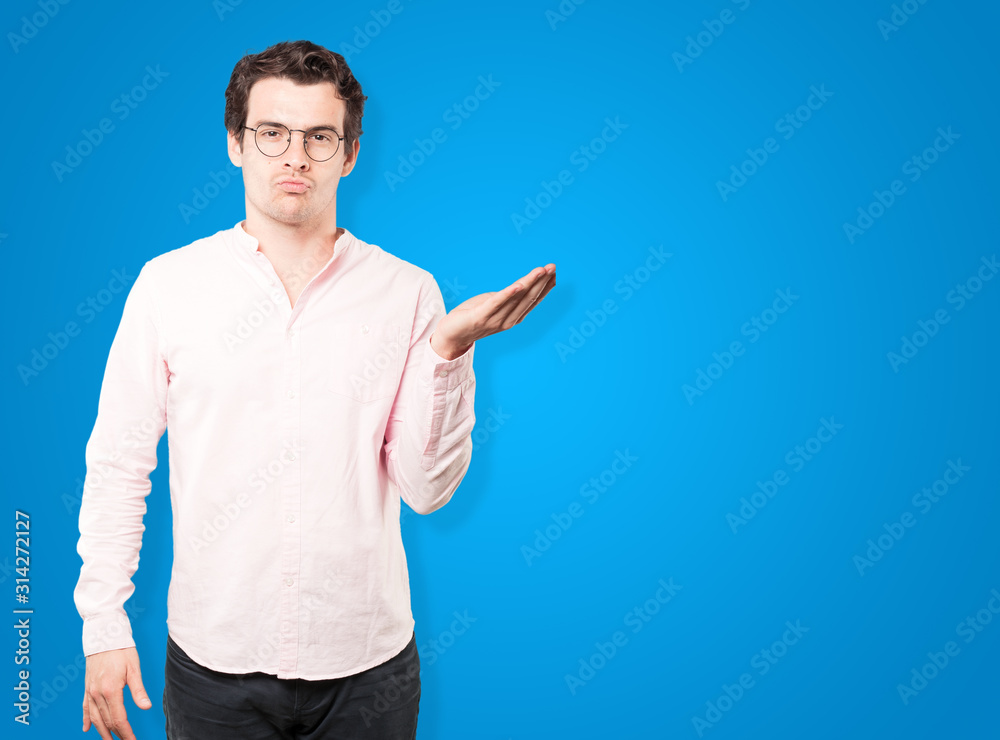 Friendly young man making a gesture of sending a kiss with his hand Friendly young man making a gesture of sending a kiss with his hand
