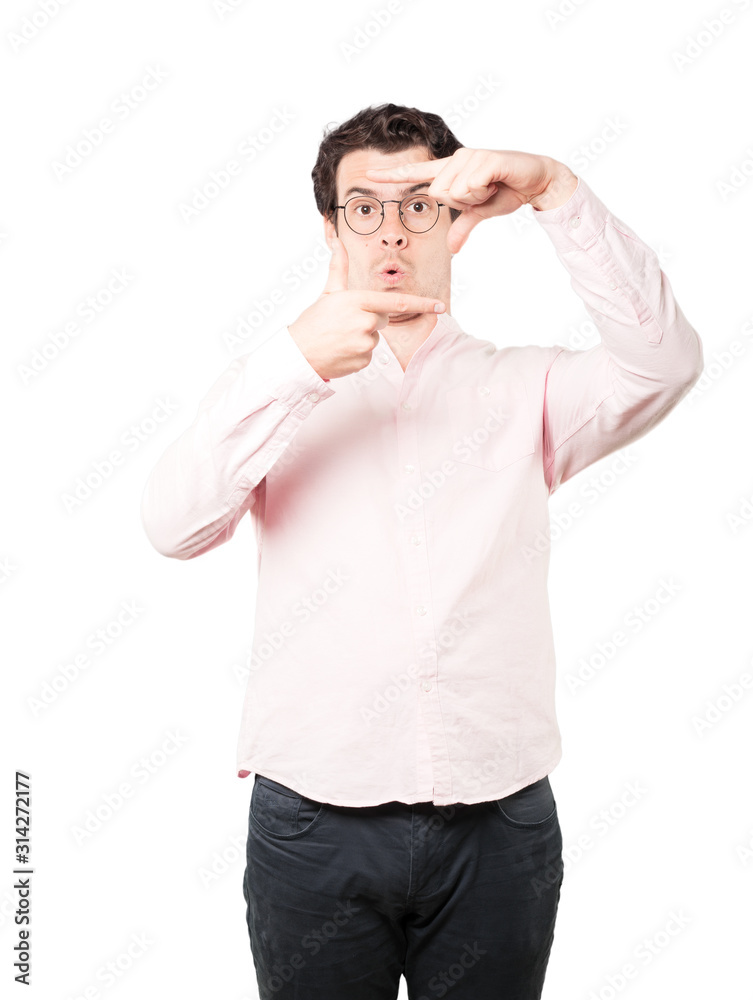 Amazed young man making a gesture of taking a photo with the hands Amazed young man making a gesture of taking a photo with the hands