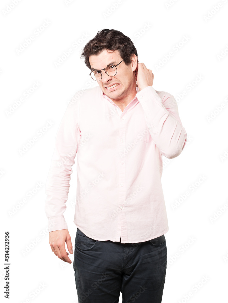 Concerned young man making a scratching gesture Concerned young man making a scratching gesture