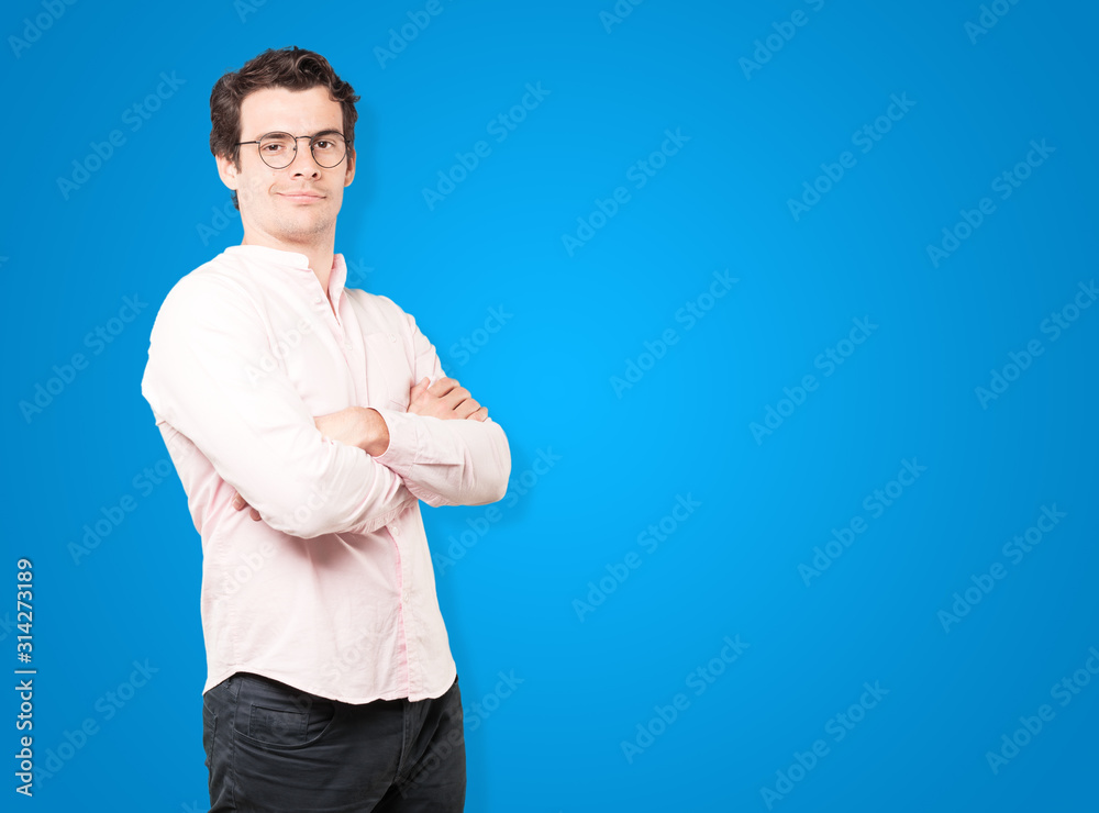 Satisfied young man with crossed arms gesture Satisfied young man with crossed arms gesture