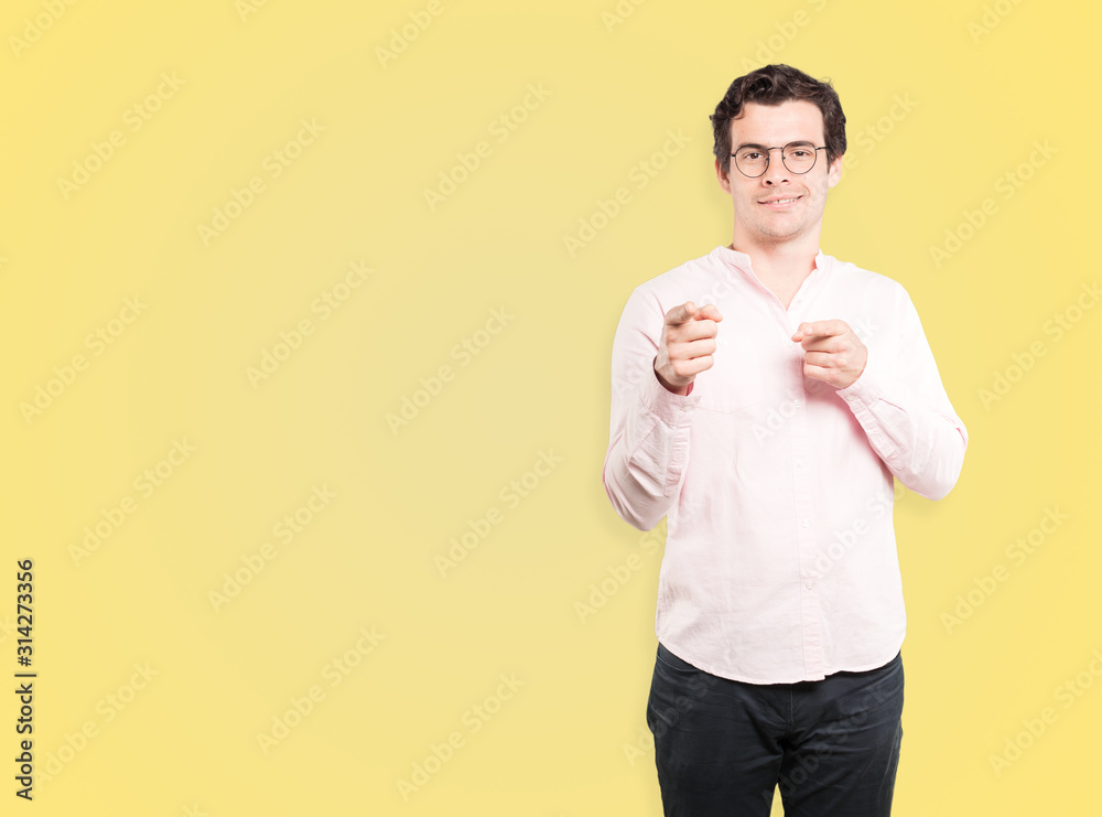 Happy young man pointing at you with his finger Happy young man pointing at you with his finger