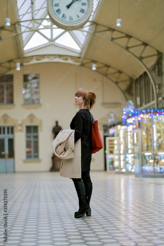Railway station. Beautiful girl is waiting for train. Woman travels light. Middle-aged lady Railway station. Beautiful girl is waiting for train. Woman travels light. Middle-aged lady