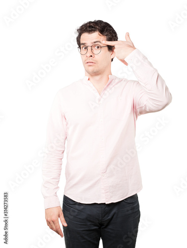 Depressed young man making a suicide gesture