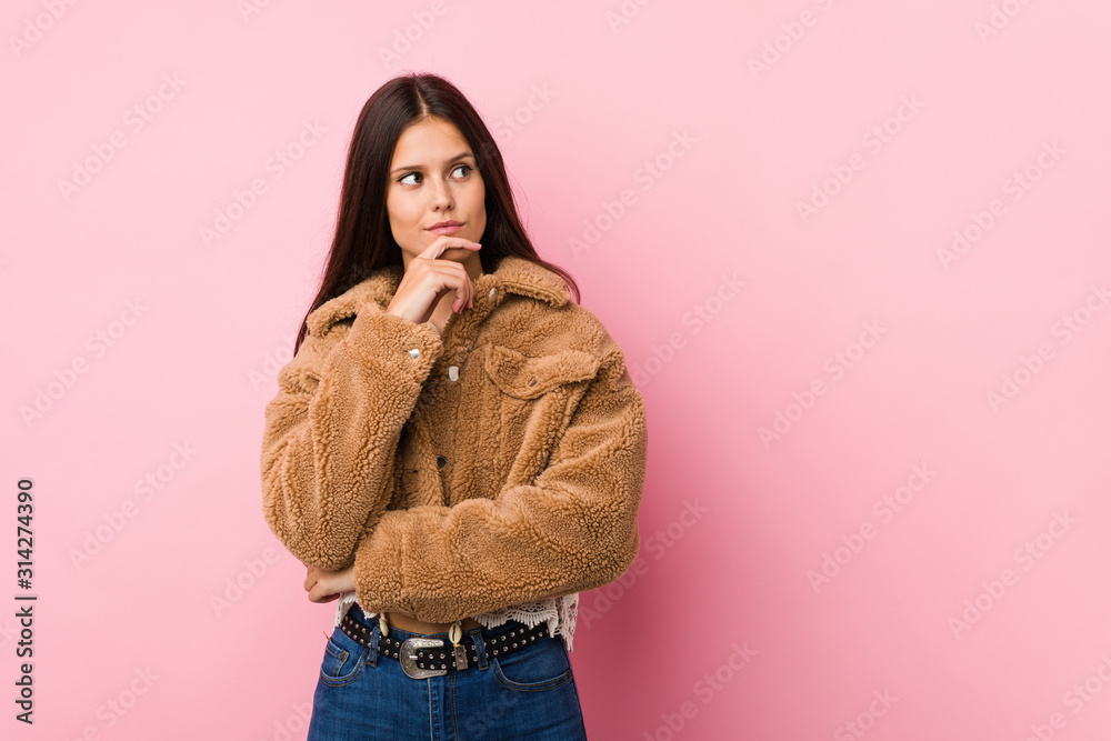 Young cute woman looking sideways with doubtful and skeptical expression. Young cute woman looking sideways with doubtful and skeptical expression.