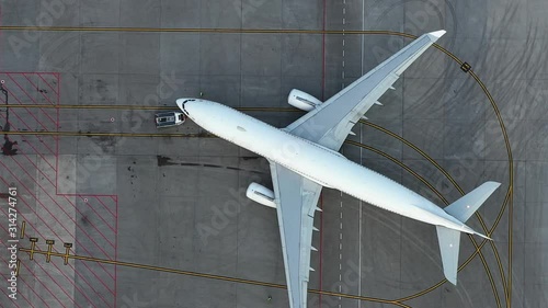 airfield. Aircraft towing. Preparing the plane for flight. Airport technical services. Airplane Service. Airbus A330 top view. Aerial view. airplane Unnamed, Pure white fezulage of an airplane.