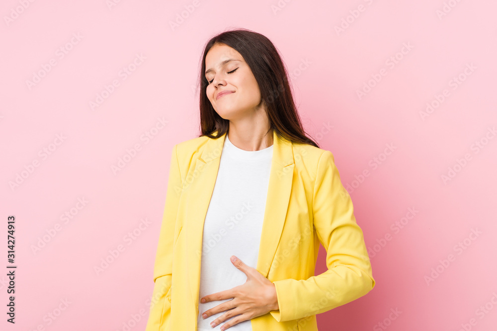 Young business woman touches tummy, smiles gently, eating and satisfaction concept. Young business woman touches tummy, smiles gently, eating and satisfaction concept.
