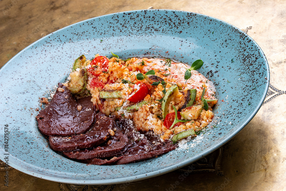 Veal tongues, stewed with bulgur. Classic retro Russian dish Veal tongues, stewed with bulgur. Classic retro Russian dish