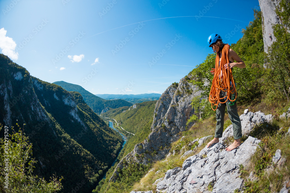 Climber in a helmet on a background of beautiful mountains.