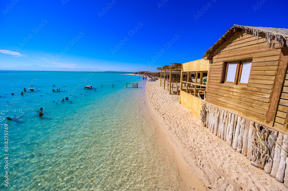 Orange Bay Beach with crystal clear azure water and white beach - paradise coastline of Giftun island, Mahmya, Hurghada, Red Sea, Egypt. Orange Bay Beach with crystal clear azure water and white beach - paradise coastline of Giftun island, Mahmya, Hurghada, Red Sea, Egypt.