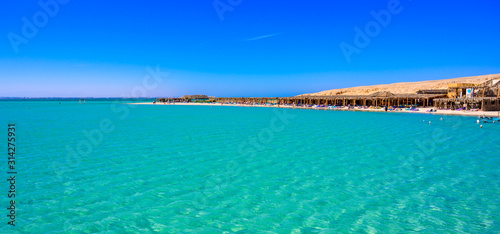 Orange Bay Beach with crystal clear azure water and white beach - paradise coastline of Giftun island, Mahmya, Hurghada, Red Sea, Egypt. © Simon Dannhauer