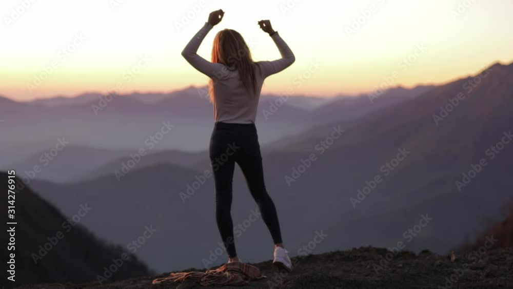 Back view of silhouette young attractive girl woman effectively drops the blanket from the shoulders and enjoy the view outdoors of mountain landscape. focus on background