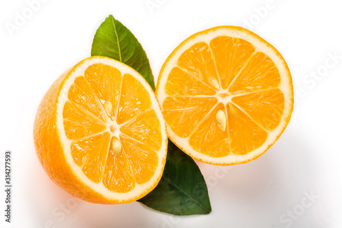 Cut in half lemon with leaves on a white background