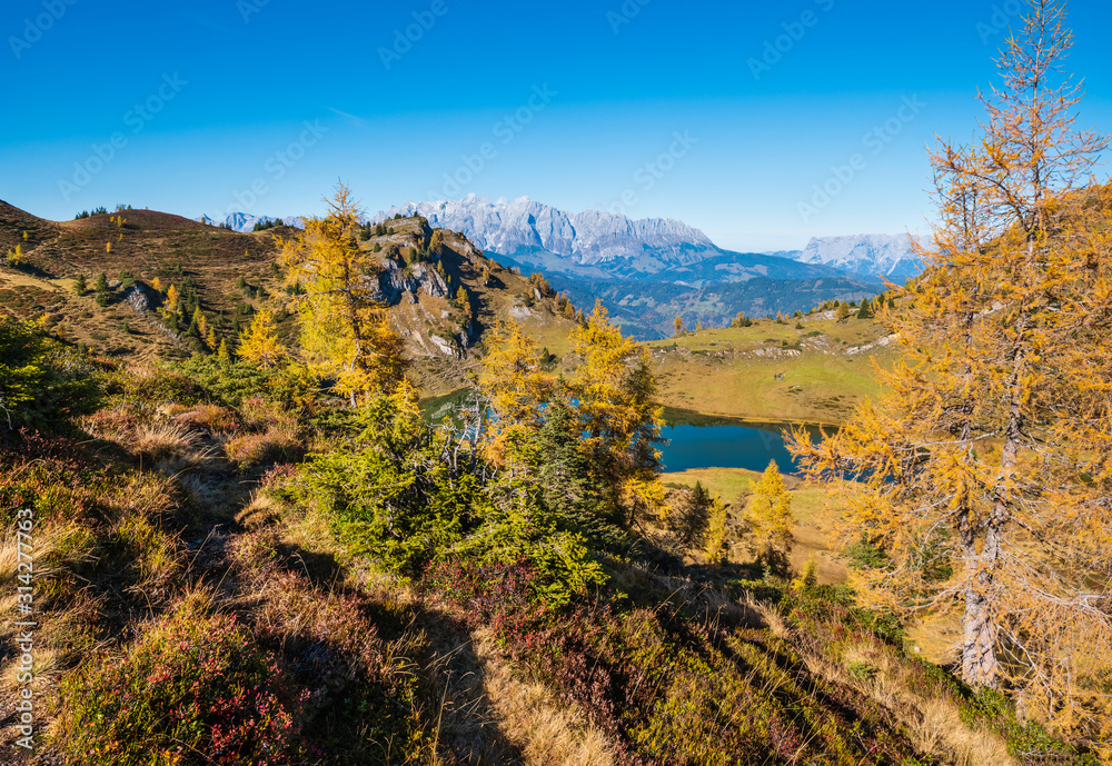 Autumn alpine Grosser Paarsee or Paarseen lake, Land Salzburg, Austria. Alps Hochkonig rocky mountain group view in far.