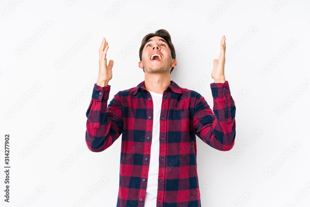 Young caucasian man posing in a pink background isolated screaming to the sky, looking up, frustrated. Young caucasian man posing in a pink background isolated screaming to the sky, looking up, frustrated.