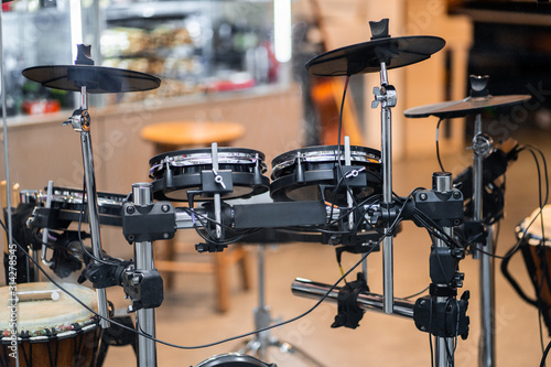 Electronic modern drum kits in a small music shop. Musical instruments, hobbies and music concept - electronic drum kit. horizontal