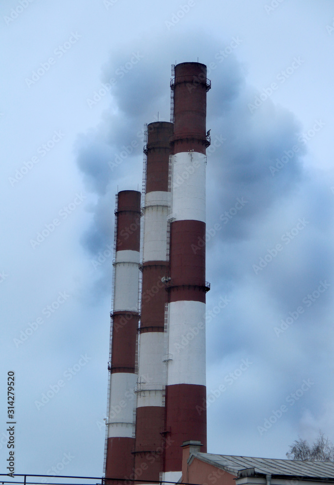 Large factory chimneys with smoke against a gray sky. Global warming image Large factory chimneys with smoke against a gray sky. Global warming image