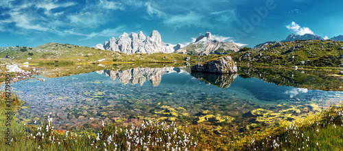Wonderful Alpine Scenery. Incredible Dolomites Alps In Sunny Day. Awesome Alpine highland with Lake in spring. Impessive Nature Landscape of Tre Cime di Lavaredo Park. Italy. Natural Bacground
