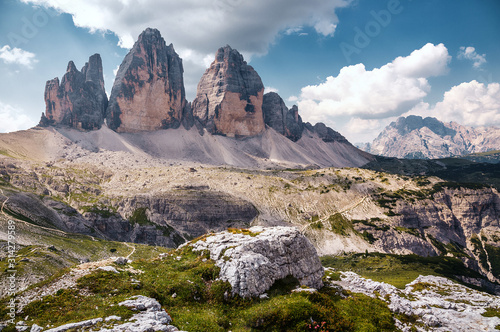 Great sunny view of the National Park Tre Cime di Lavaredo, Panoramic view of three spectacular mountain peaks. Awecome nature landscape. Amazing mountain valley under sunlight. Dolomites Alps photo