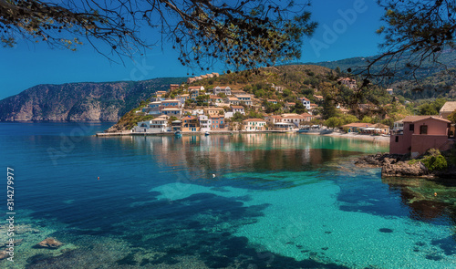 Wonderful summer seascape of Ionian Sea. Wonderful place for holiday. Amazing Greece. Picturesque colorful village Assos in Kefalonia. Turquoise colored bay in Mediterranean sea. Amazing postcard
