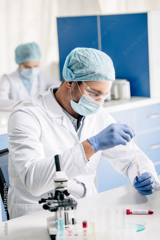 selective focus of genetic consultant doing dna test in lab selective focus of genetic consultant doing dna test in lab