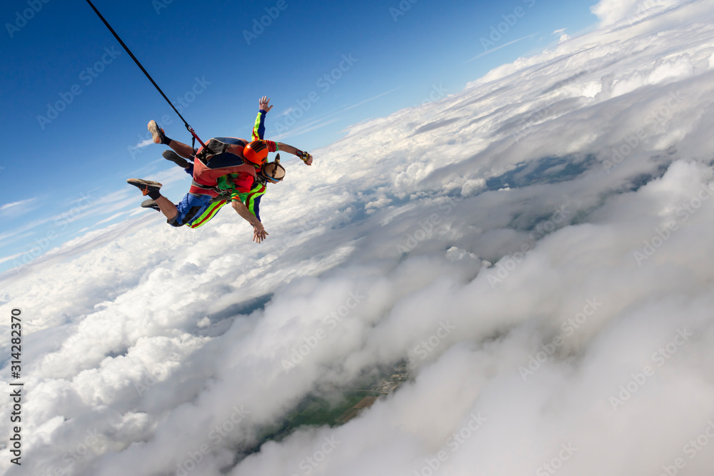 Tandem jump. The instructor and the student in free fall. Tandem jump. The instructor and the student in free fall.
