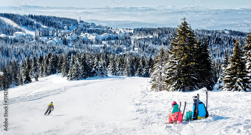 Skiers admiring the view of mountain in Kopaonik winter ski resort  Serbia