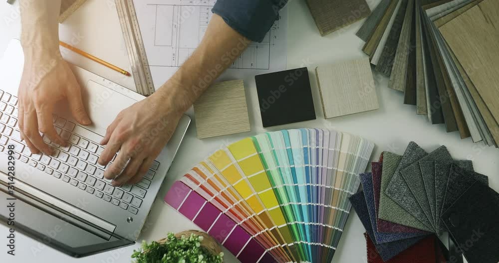 designer working on laptop in office for new house interior design. top view