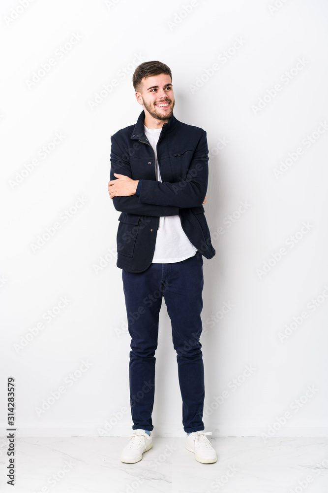 Full body young caucasian man isolated smiling confident with crossed arms. Full body young caucasian man isolated smiling confident with crossed arms.