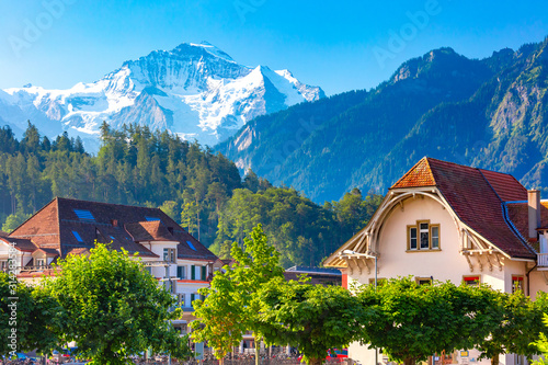 Houses in Old City of Interlaken, important tourist center in the Bernese Highlands, Switzerland. The Jungfrau is visible in the background photo