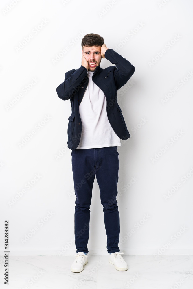 Full body young caucasian man isolated whining and crying disconsolately. Full body young caucasian man isolated whining and crying disconsolately.
