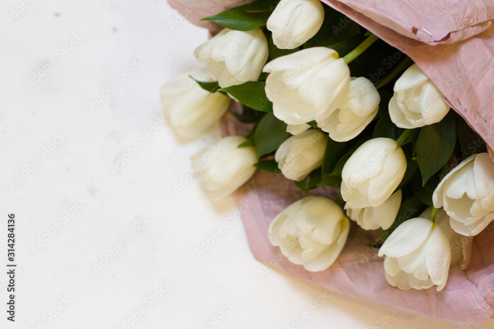the flowers are white tulips. bouquet of tulips for Valentine's day. birthday present. beautiful flowers for women's day. many colors. white background with tatami. space for text. the flowers are white tulips. bouquet of tulips for Valentine's day. birthday present. beautiful flowers for women's day. many colors. white background with tatami. space for text.