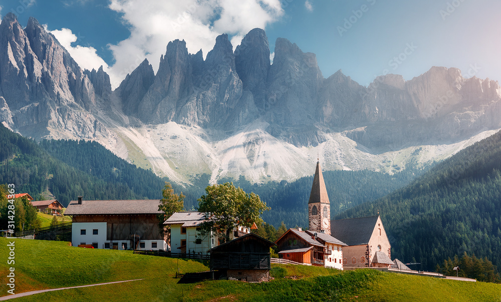 Wonderful Sunny Landscape of Dolomites Alps. Scenic Imege of Alpine Valley With Majestic Rocky Mountains peaks and perfect sky, Beautiful View on Famouse place Santa Maddalena village, Dolomiti, Italy