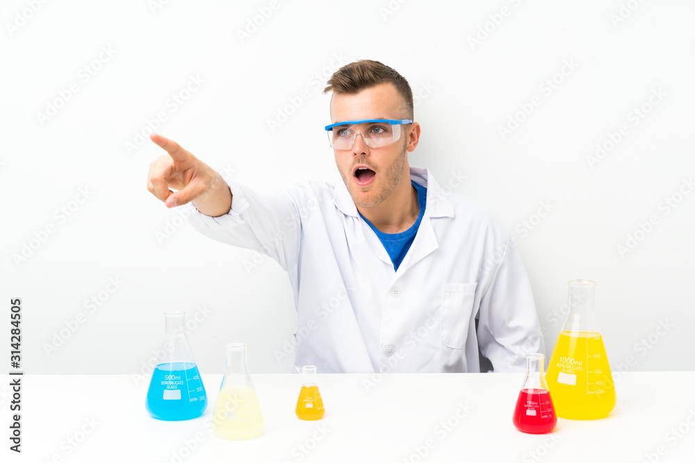 Young scientific with lots of laboratory flask pointing away Young scientific with lots of laboratory flask pointing away
