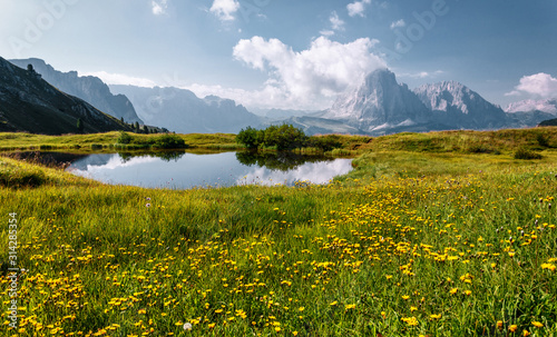 Wonderful landscape in Val Gardena with lake on a sunny day. Scenic image of famous Sassolungo peak. Amazing nature landscape in Dolomites Alps. Dolomiti, Trentino Alto Adige, Bolzano, Italy, Europe