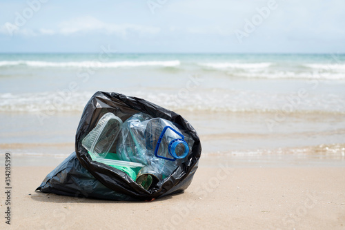 garbage bag on the beach. © nito