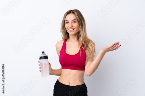 Young sport woman over isolated white background with sports water bottle