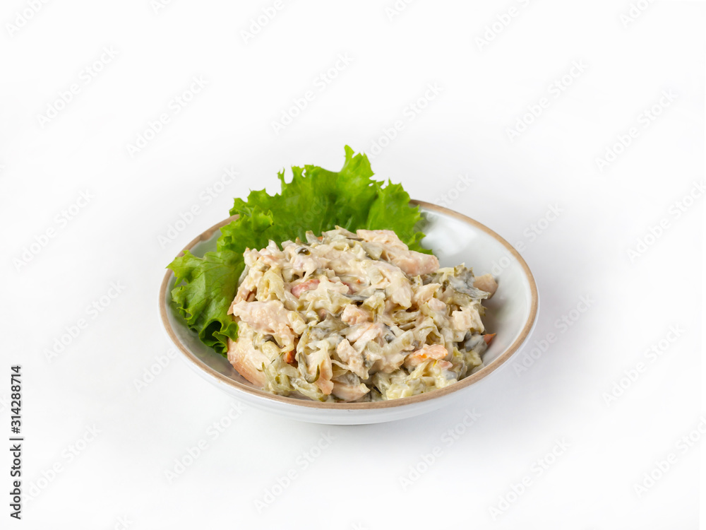 Salad with ham, bell pepper, mushrooms, pickles, seasoned with mayonnaise, on a white plate Salad with ham, bell pepper, mushrooms, pickles, seasoned with mayonnaise, on a white plate