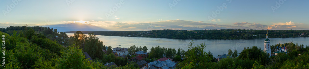 The landscape is with sunset. The sunset sky is reflected in the water of the Volga river. Ples, Ivanovo region, Russia.