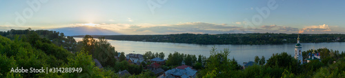 Fototapeta Naklejka Na Ścianę i Meble -  The landscape is with sunset. The sunset sky is reflected in the water of the Volga river. Ples, Ivanovo region, Russia.