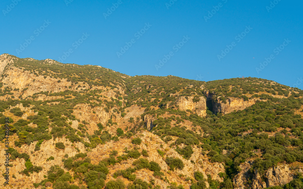 Beautiful mountains aerial landscape view. Mountain peak of rocks covered by trees. Mountain chain. High resolution photo